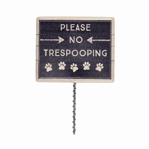 Decorative black sign with 'Please No Trespooping' text and paw prints in white