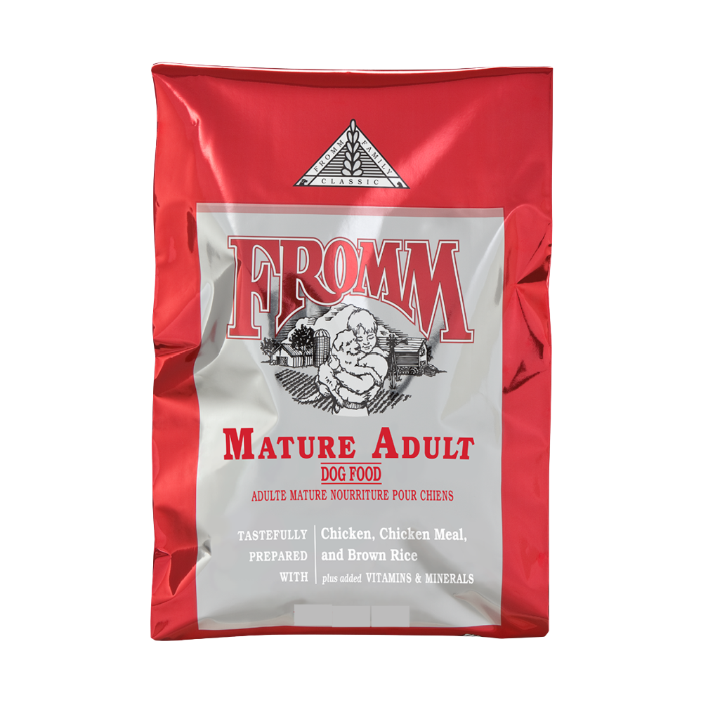 Red and silver bag of Fromm Mature Adult dog food on a white background.