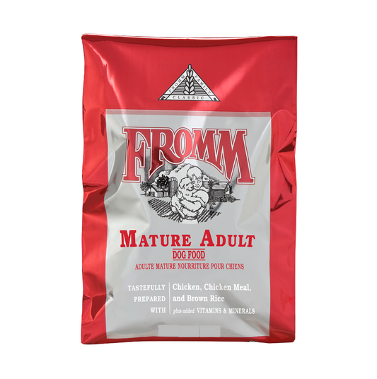 Red and silver bag of Fromm Mature Adult dog food on a white background.