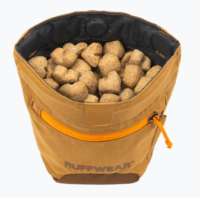 Ruffwear dog treat bag filled with treats on a white background
