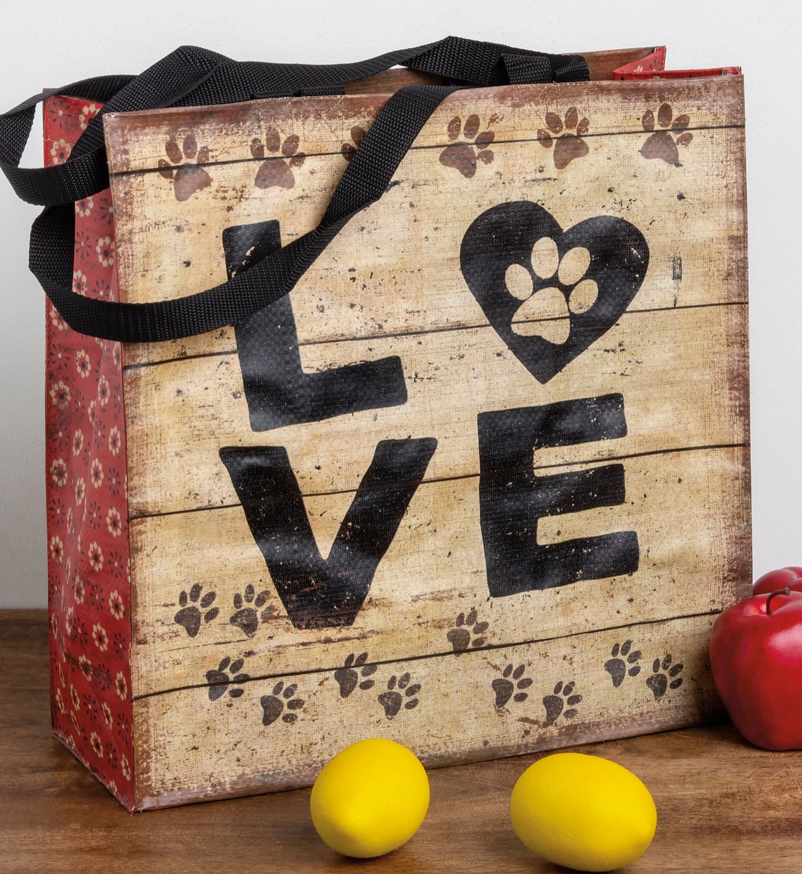 Wooden look tote bag with 'LOVE' and paw prints, on a wooden surface.