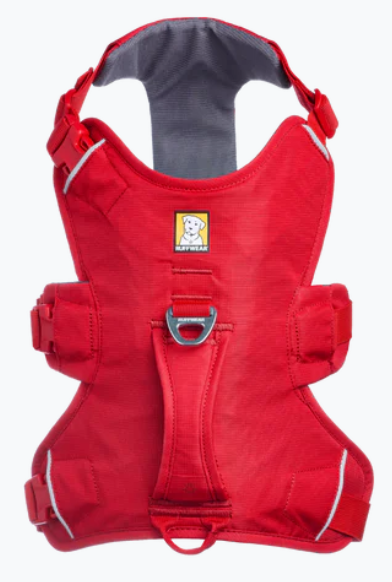 Red dog harness with a visible brand logo 